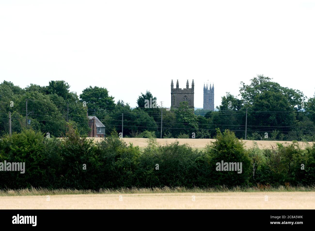 A view of St. Michael`s Church, Budbrooke, with St. Mary`s Church, Warwick, in the distance, Warwickshire, UK Stock Photo